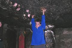 04 Peter Ryan At Milarepa Cave Near Nyalam Peter Ryan does his best Milarepa imitation at the low-ceilinged Milarepa Cave in 2005. The cave is formed by a large overhang supported by a smaller rock. Milarepa supposedly used his magic feats by raising the ceiling of the cave with his bare hands while Rechungpa slid in the other piece. You can still see his handprints in the roof.